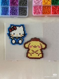 the hello kitty and pooh bead magnets are next to each other