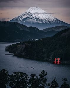 the mountain is covered in snow and has a red structure on it