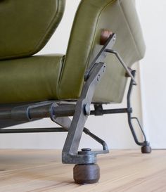 a green chair sitting on top of a hard wood floor