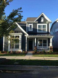 a gray house with white trim and windows