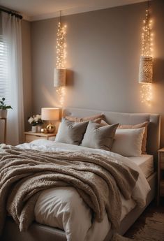 a bedroom with lights hanging above the bed and pillows on the bed, along with two nightstands