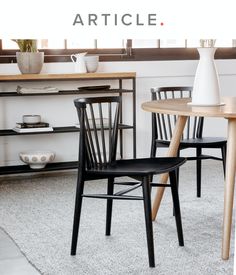 two black chairs sitting next to each other on top of a white carpeted floor