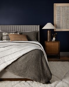 a bedroom with blue walls and white carpet