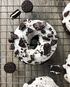 chocolate chip cookies and oreo doughnuts on a cooling rack with white frosting