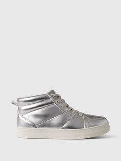 These sneakers are made with a vegan metallic leather upper.  Rubber gripper sole.  Lace-up styling.  This product was made in a factory that invests in gender equality and women’s empowerment.  Through RISE Reimagining Industry to Support Equality) and Gap Inc. ’s program P. A. C. E.  Personal Advancement & Career Enhancement), we support people who make our clothes to build the skills, knowledge, confidence, and resilience needed to advance in work and life.  Learn more here.  For more fit and Metallic Sneakers, Gap Kids, Support People, Metallic Leather, Up Styles, Gap, High Tops, Metallic Silver, Leather Upper