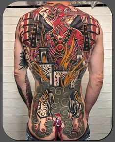 the back of a man with tattoos on his body