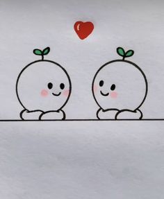 two apples sitting side by side on top of a white surface with a red heart above them