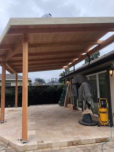 an outdoor covered patio with a blower on the ground