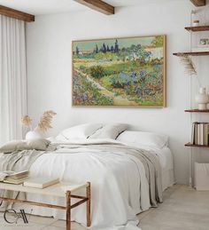 a white bedroom with a painting on the wall