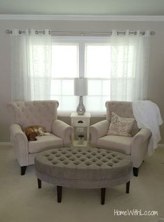 a living room with two couches and a coffee table in front of a window