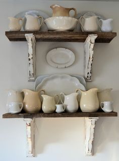 two wooden shelves with dishes and cups on them