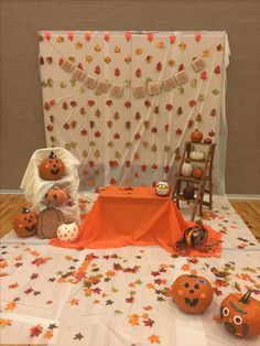 the table is decorated with pumpkins and decorations