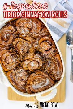 cinnamon rolls in a baking dish with text overlay