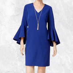 V-Neck Double Ruffled Sleeves Hidden Back Zipper With Hook-And-Eye Closure Polyester Elastane Crepe With Polyester Lining Dry Clean Note: Gold Necklace Not Included Blue Ruffle Sleeve Workwear Dresses, Blue Ruffle Sleeve Dress For Work, Chic Blue Bell Sleeve Dress, Blue Ruffle Sleeve Dress For Party, Blue Ruffle Sleeve Dress For Formal Occasions, Blue Ruffle Sleeve Party Dress, Ruffled Sleeves, Bell Sleeve Dress, Bell Sleeves