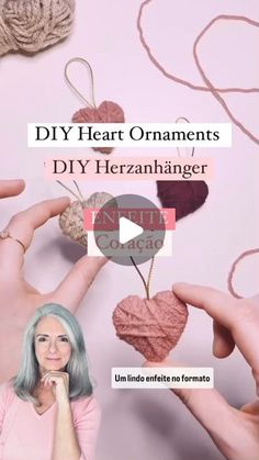 two hands are holding yarn hearts with the words diy heart ornaments