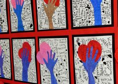 several handprints are displayed on a wall with red and blue paper in the shape of hands