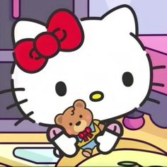 hello kitty is holding a teddy bear in her arms