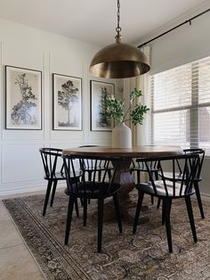 A circular wooden dining room table with three large vertical prints of trees hung on the wall in the corner. Organic Dining Room, Organic Modern Dining Room, Farmhouse Area Rug, Coffee Shop Office, Natural Farmhouse, Dark Dining Room, Summer Room, Toilet Decor, Room Dark