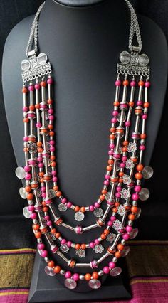 Gather compliments wearing this handcrafted multi strand colorful Afghani Kuchi coin necklace in a silver color. This is a LOT of necklace! Five strands. Outer row has stamped circular discs in an eternity pattern, middle row has adorable filigree flowers with colored centers, and the inner row has stamped discs resembling coins. Between each row is a row of beads separated by long tubular silver colored beads. Beads attach at the top to a beautiful peacock motif, and then a pretty chain. Lobste Oxidised Jewelry, Oxidized Jewellery, Diy Jewelry Set, Diy Necklace Making, Diy Fabric Jewellery, Oxidised Silver Jewelry, Belly Dance Jewelry, Fabric Jewellery, Dance Necklace