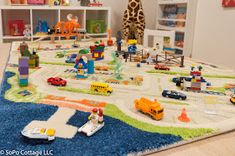 a child's playroom with toys and bookshelves on the floor in front of it