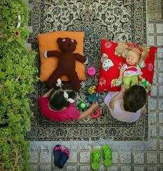 two girls are playing with stuffed animals on the floor