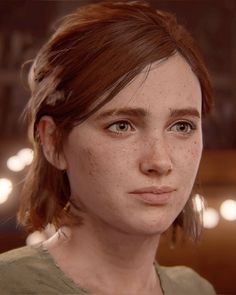 a woman with freckles on her face looks at the camera and stares into the distance