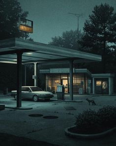 an empty gas station at night with a car parked in the parking lot next to it