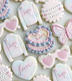 cookies decorated with pastel colors and embellishments are arranged on a table