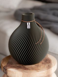 a green vase sitting on top of a wooden table