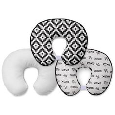 three pieces of white and black patterned travel pillow with two pillows on each side, one in