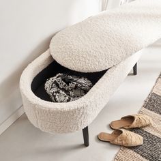 a white bench sitting next to a pair of shoes on top of a carpeted floor