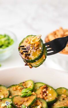 someone is holding up a piece of zucchini with nuts