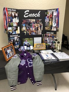 a table topped with pictures and other items next to a sign that says emoch