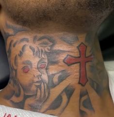 a man with a tattoo on his neck has a cross and jesus behind the head