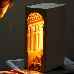 a person is working on an art project in front of a tabletop with the image projected onto it