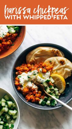 a bowl filled with chickpeas and cucumbers next to a plate of pita bread