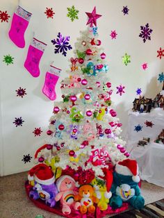 a white christmas tree decorated with colorful ornaments