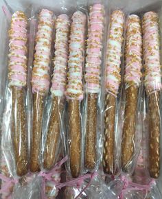 there are many pretzels wrapped in plastic and tied with pink ribbon around them