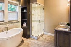 a bathroom with a large tub and walk in shower