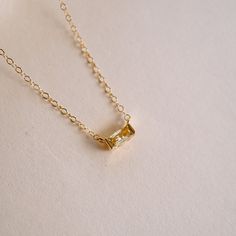 For a stunningly subtle (yet powerful) reminder of light and optimism, this Tiny November Birthstone Necklace is your go-to! Designed with a dainty citrine-hued CZ, it's a small but meaningful reminder of abundant opportunities and warm positivity. NECKLACE FEATURES: 16k gold plated citrine hued cubic zirconia birthstone charm 14k gold filled chain & findings Necklace comes with coordinating November birth month card