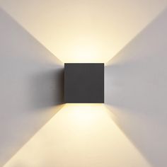 a square light fixture mounted on the wall