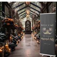 a sign that is in the middle of a walkway with candles on it and some plants