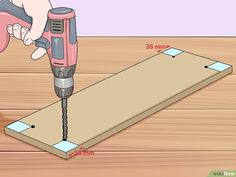 a drill is being used to make a piece of wood