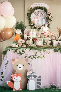 a table topped with lots of desserts and balloons