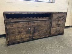 a large wooden cabinet with two doors and drawers