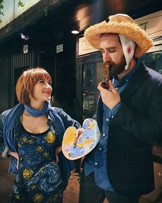 a man in a straw hat eating something next to a woman wearing a blue dress