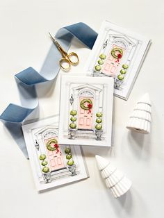 three cards with scissors and ribbon on top of each one that has an image of a pink door