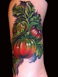 a close up of a tattoo with tomatoes on it