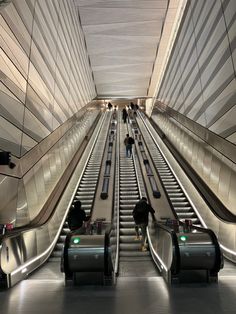 an escalator with people moving down it