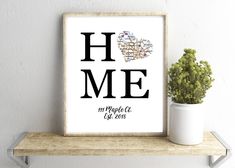 a white shelf with a potted plant on top of it and a framed print that says home